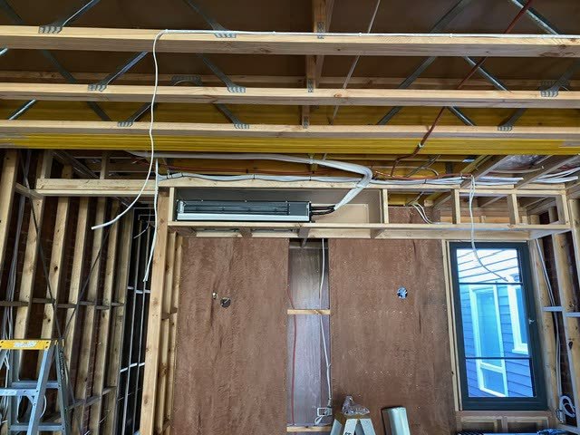 Daikin VRV bulkhead unit fitted into the framing of a new build still in timber frame.
